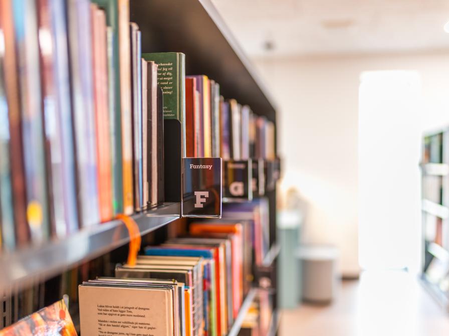 Billeder viser en bogreol på Nørre Nebel Bibliotek